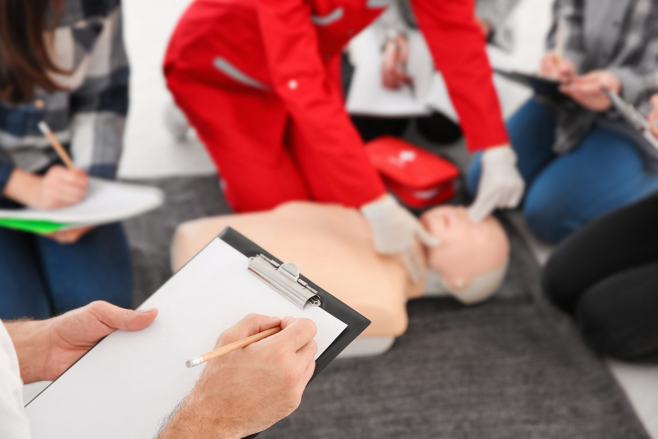 Man with clipboard in first aid class