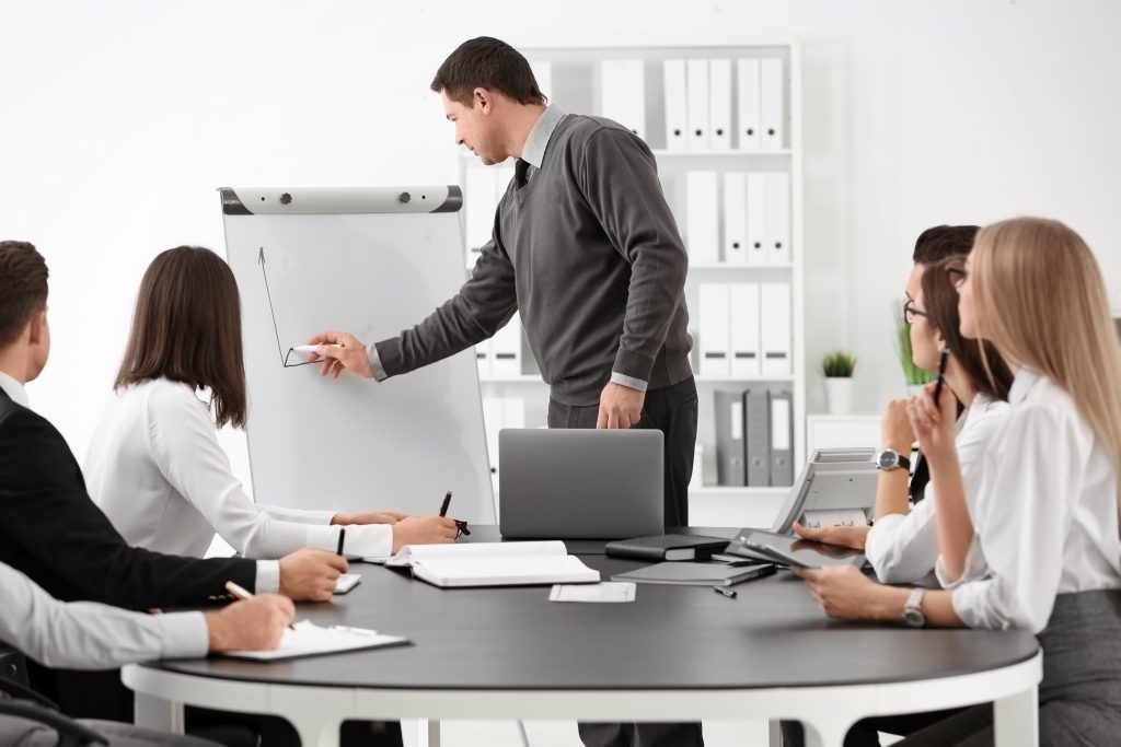 Group of people with business trainer at management seminar