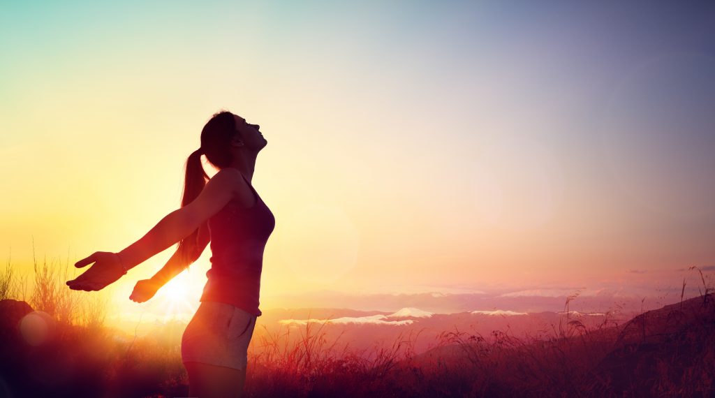 Woman stretching in sunset