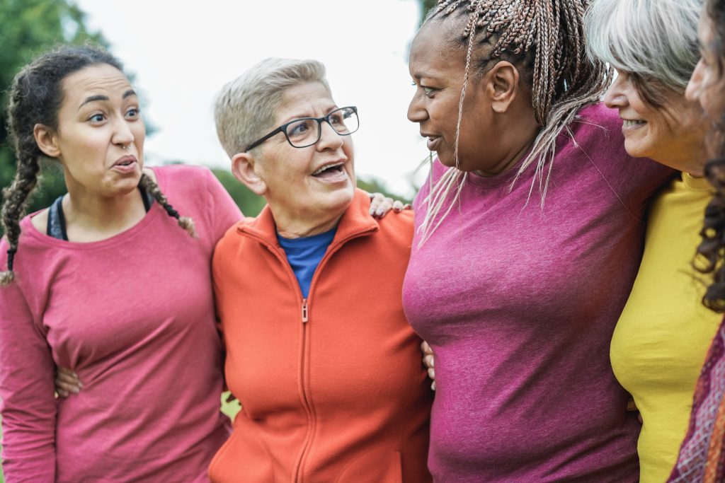 Diverse multi generational women having fun together - Main focus on african senior female ear