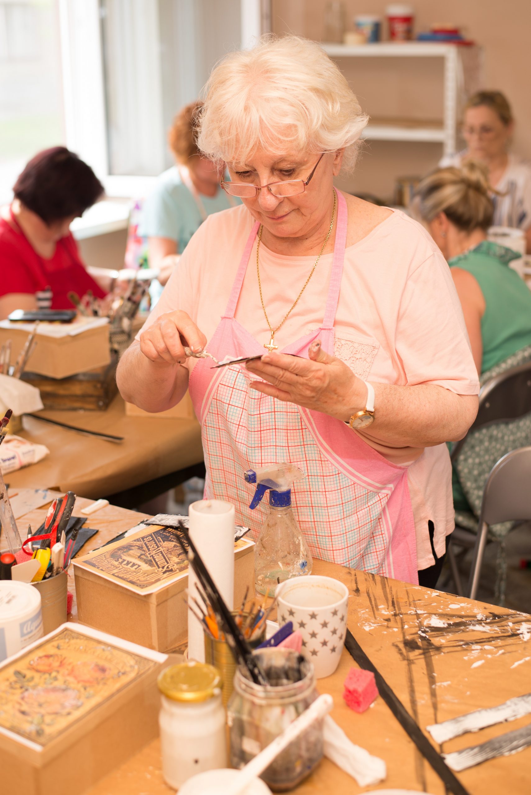 Women in art workshop making decoupage boxes