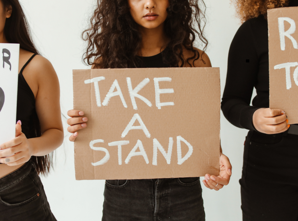 Three women holding placards 