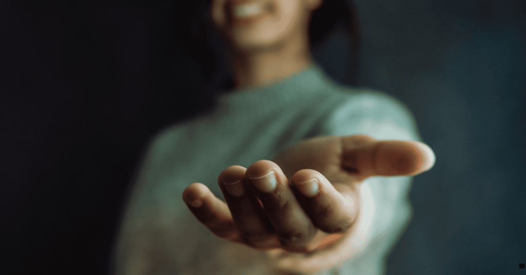 Black woman holding out a helping hand