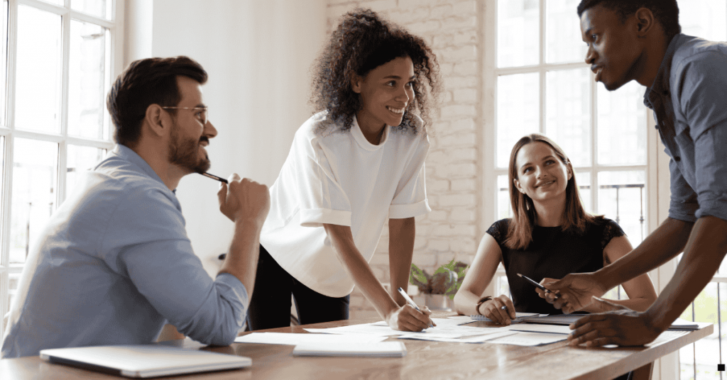 A group of people discussing in a board room
