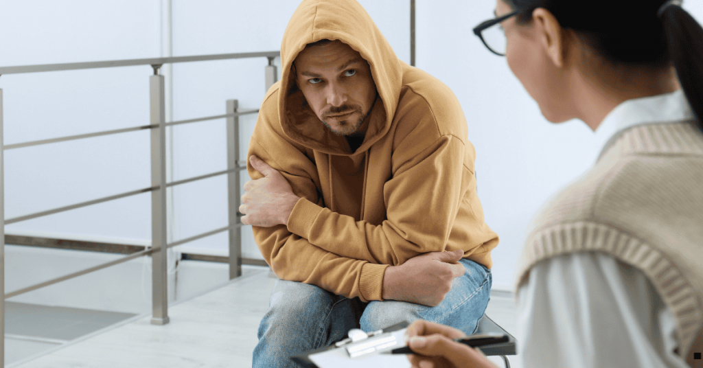 White male in a brown hoodie at therapy