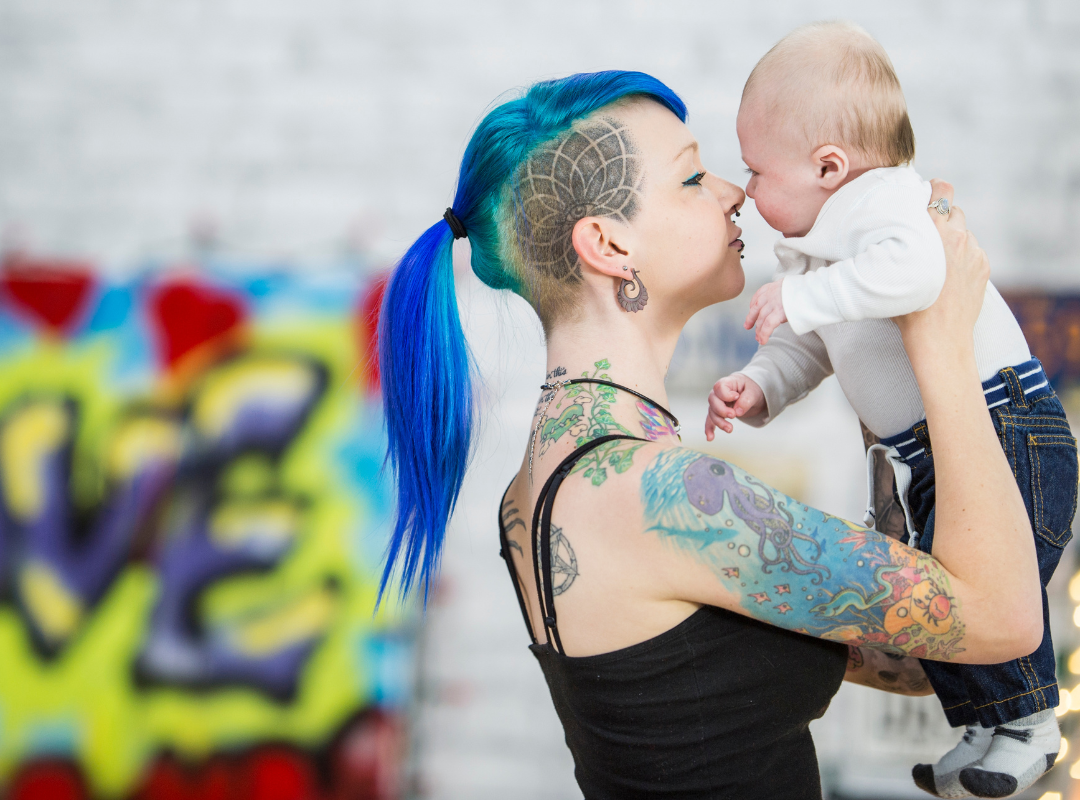 Single mother kissing her baby