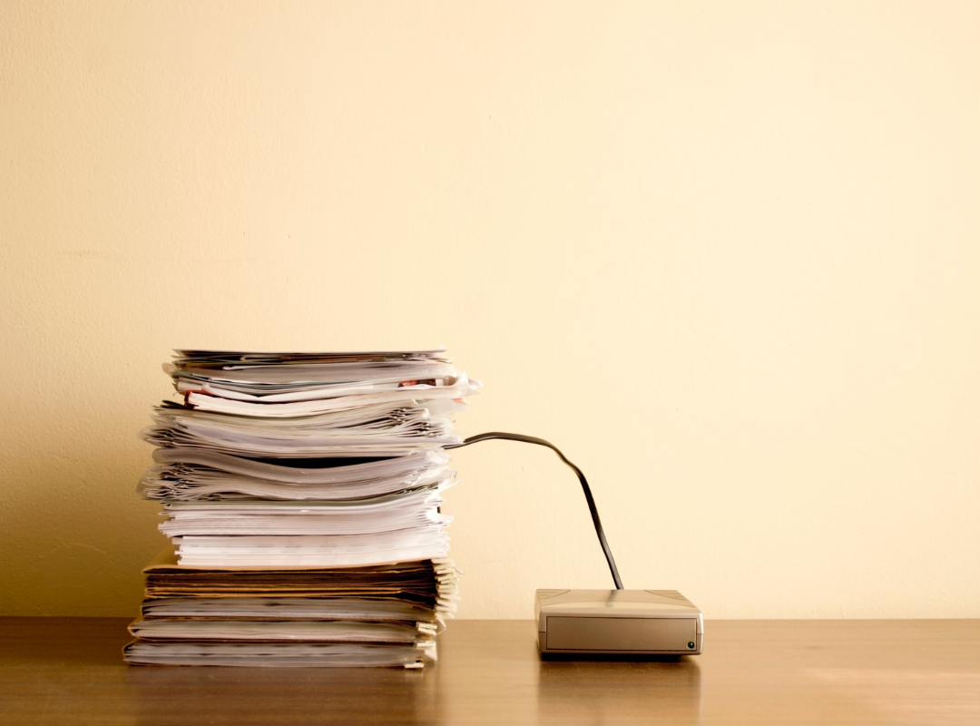 a stack of papers converted digitally and saved onto a hard drive