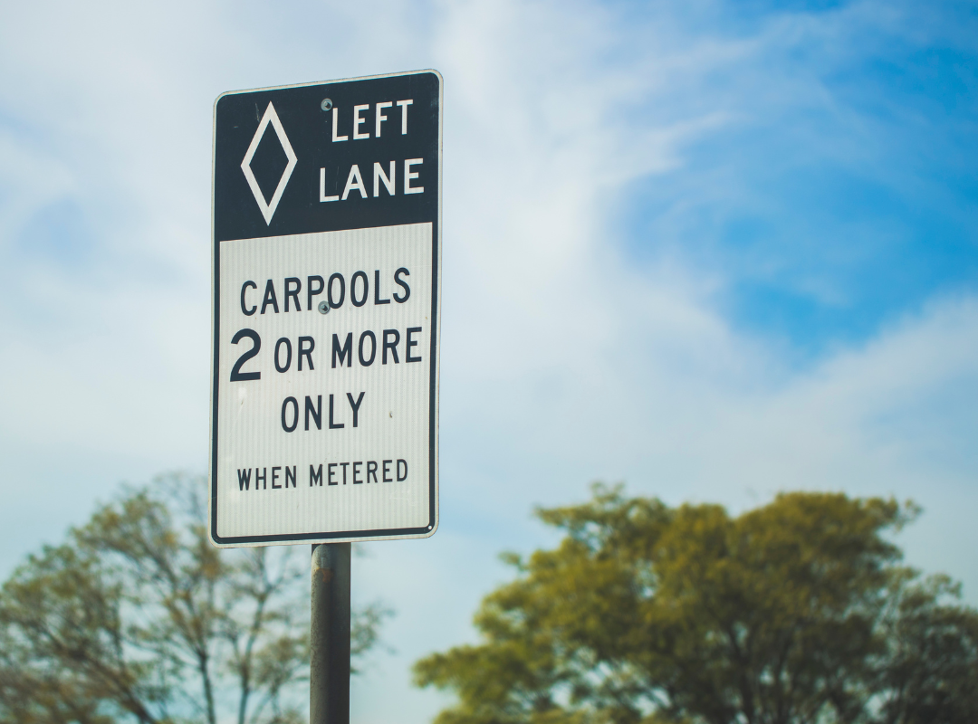 A road sign showing signage for the carpool lane