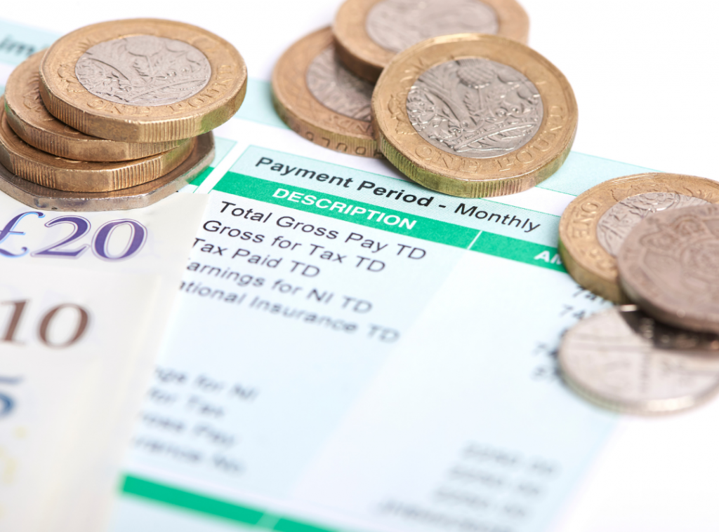 Payment slip, coins and British pounds