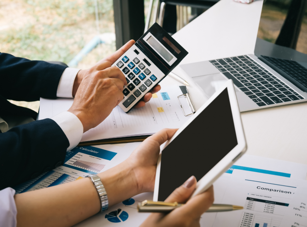Expense reporting with a man holding a calculator and woman holding an iPad