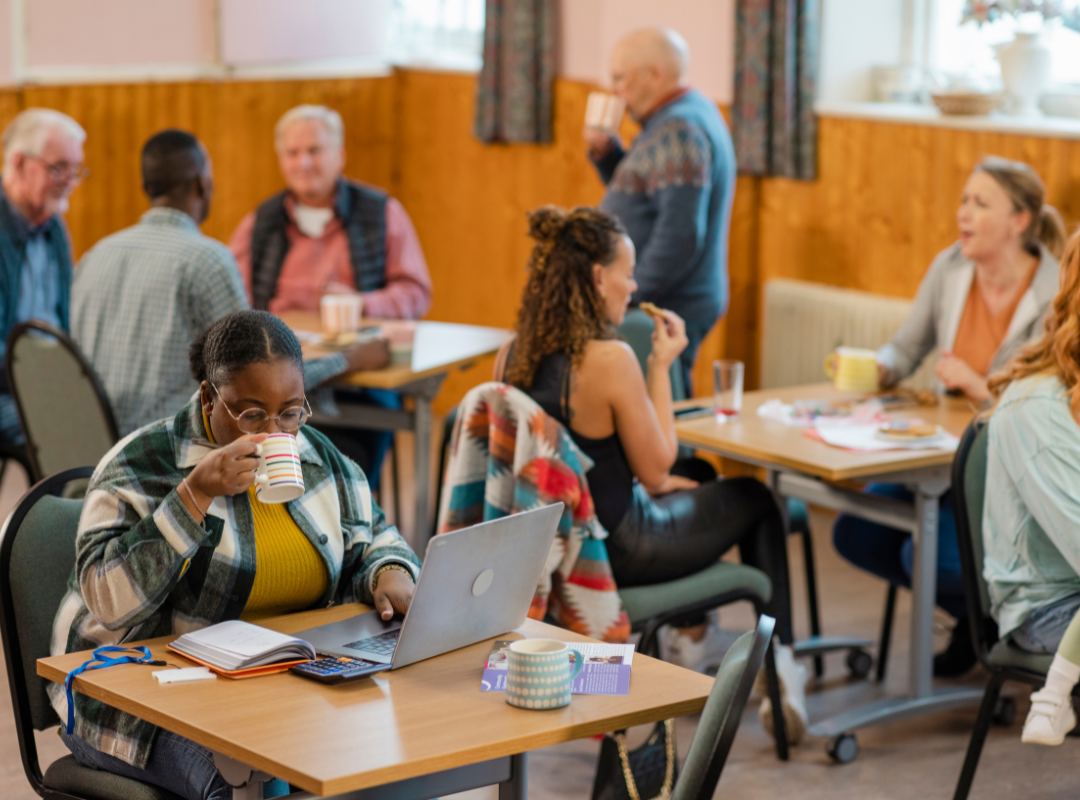A black woman drinking tea at a Resource hub